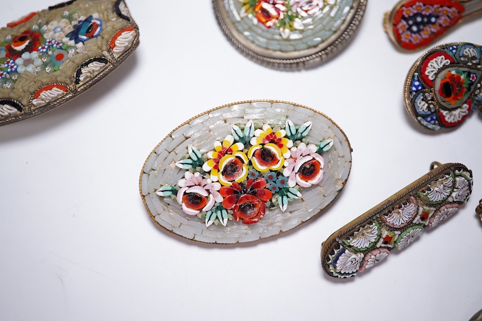 A collection of thirty-one micro-mosaic brooches, including fourteen mixed guitar and banjo shaped brooches, six large oval brooches and seven smaller brooches, three long brooches and a star shaped brooch. Condition - g